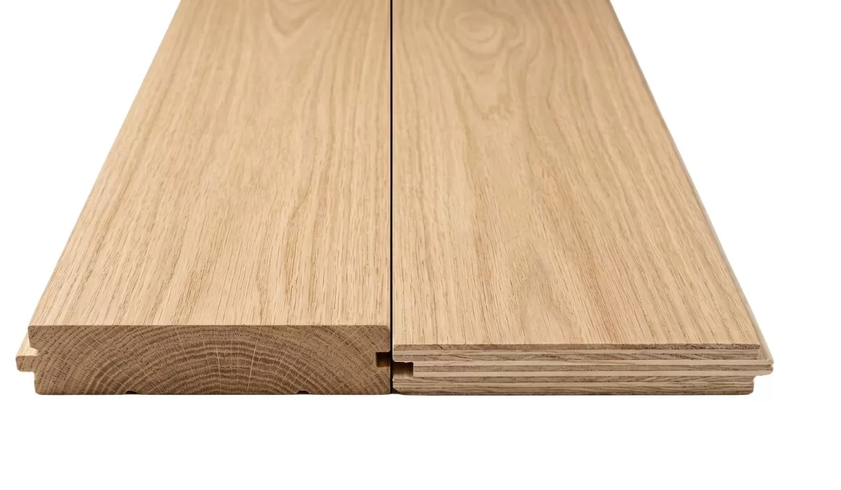 Side-by-side comparison of solid hardwood and engineered hardwood planks showing construction difference